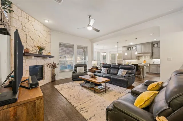 a living room with furniture kitchen view and a fireplace