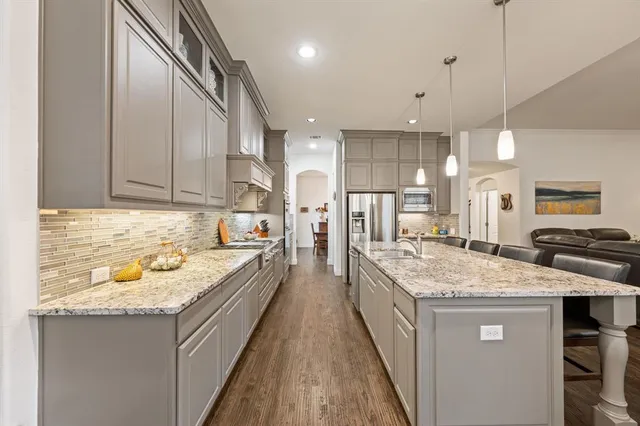 a kitchen with a sink stove and cabinets