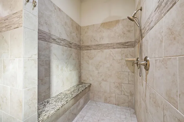 a spacious bathroom with a bathtub sink and mirror