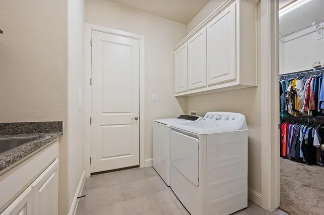 a bathroom with a granite countertop tub sink and mirror