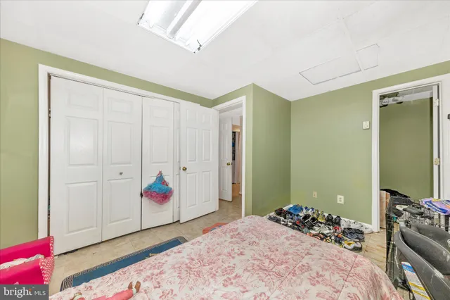 a bedroom with bed and furniture