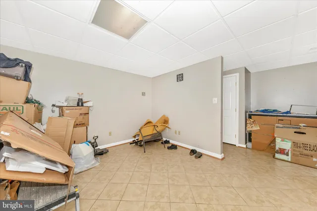 a room with gym equipment and view of living room