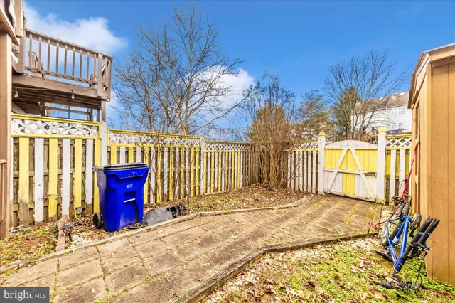 a view of a backyard with wooden fence