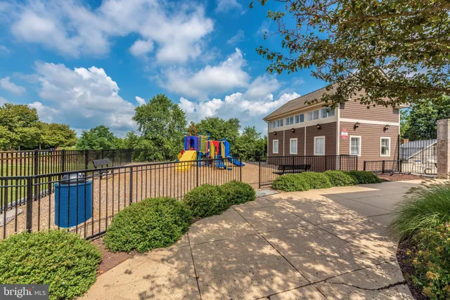 a view of a pathway with a wrought fence