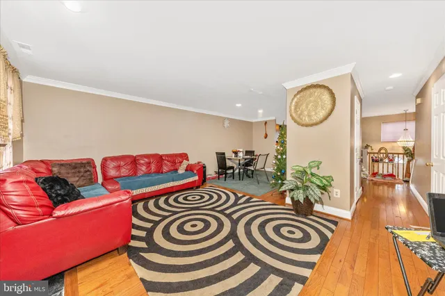 a view of a room with furniture and wooden floor