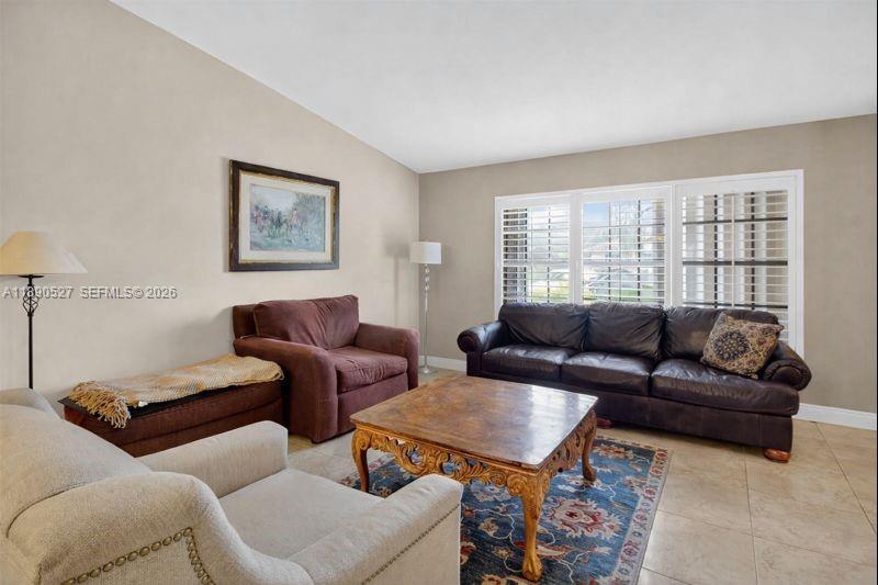 15181 Southwest 156th Terrace Miami, FL 33187 - Photo 13 of 32 a living room with furniture and a large window