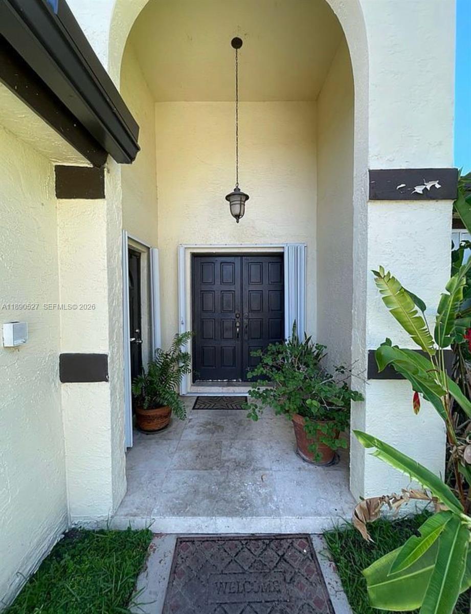 15181 Southwest 156th Terrace Miami, FL 33187 - Photo 16 of 32 a front view of a house with a yard