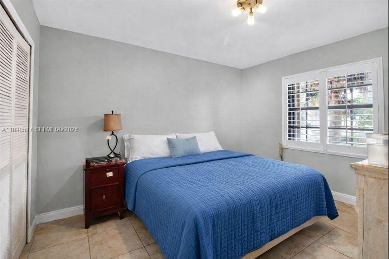 15181 Southwest 156th Terrace Miami, FL 33187 - Photo 21 of 32 a bedroom with a bed and a window