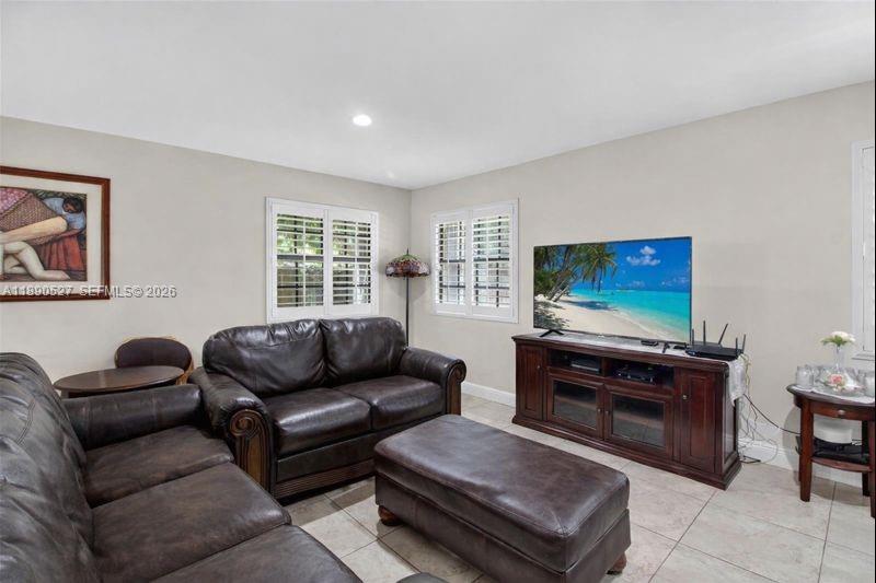 15181 Southwest 156th Terrace Miami, FL 33187 - Photo 23 of 43 a living room with furniture and a flat screen tv