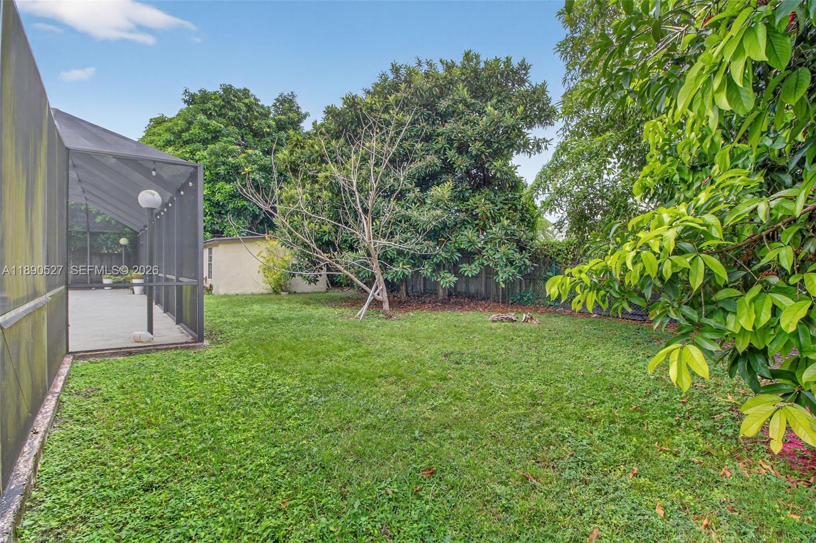 15181 Southwest 156th Terrace Miami, FL 33187 - Photo 33 of 43 a view of a garden with a tree in the grass