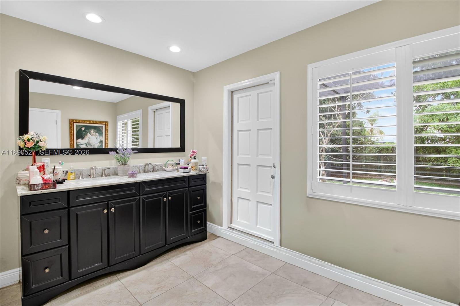 15181 Southwest 156th Terrace Miami, FL 33187 - Photo 41 of 43 a spacious bathroom with a granite countertop sink mirror and a