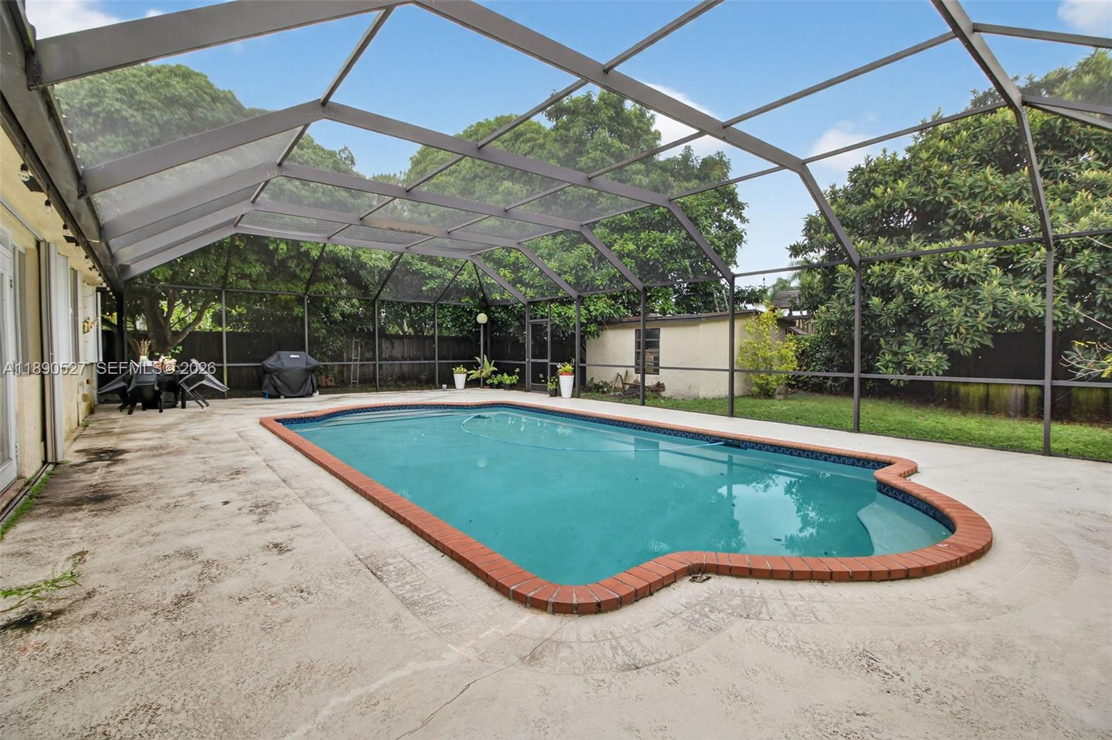 15181 Southwest 156th Terrace Miami, FL 33187 - Photo 7 of 43 a view of a swimming pool with a patio
