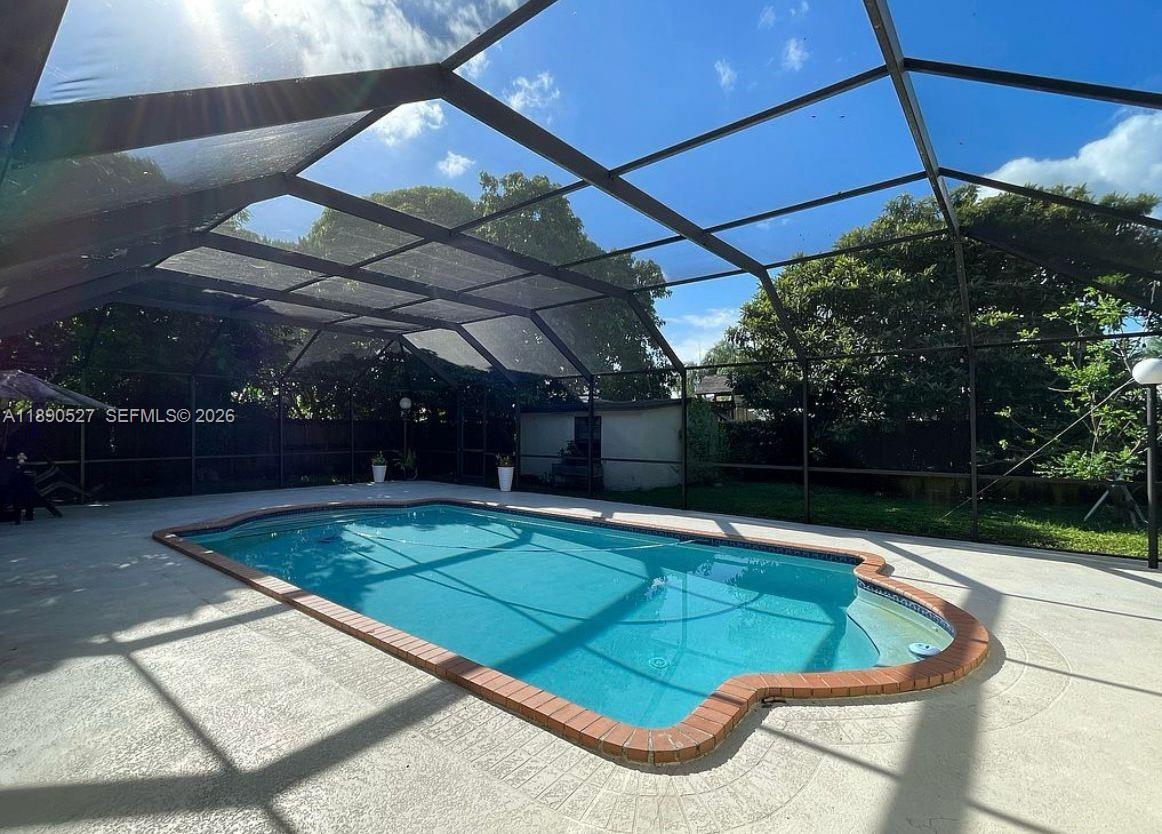 15181 Southwest 156th Terrace Miami, FL 33187 - Photo 10 of 43 a view of a pool with an outdoor space