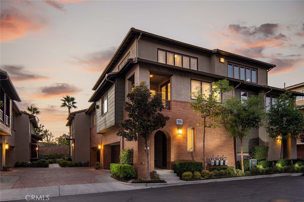 7676 Papyrus Place, Unit 4 Rancho Cucamonga, CA 91739 - Photo 1 of 1 a front view of a house with plants and trees