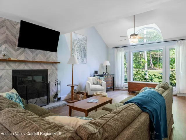 a living room with furniture fireplace and flat screen tv