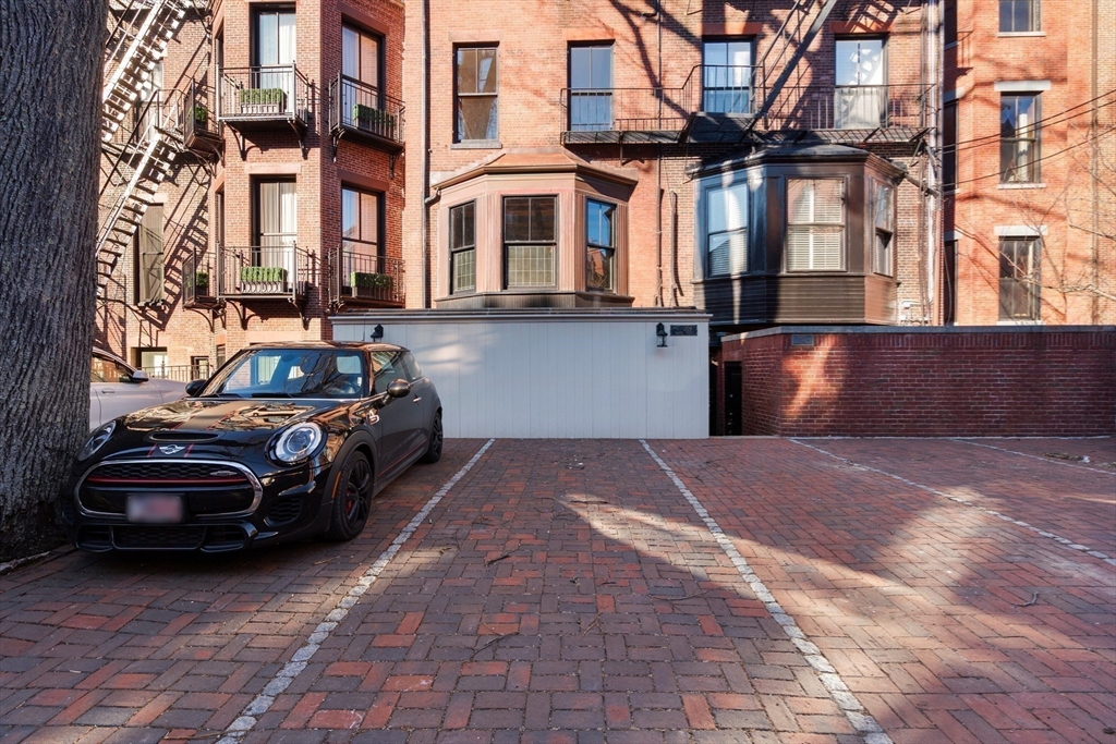 357-359 Beacon Street, Unit 4 Boston, MA 02116 - Photo 11 of 12 a couple of cars parked in front of a house