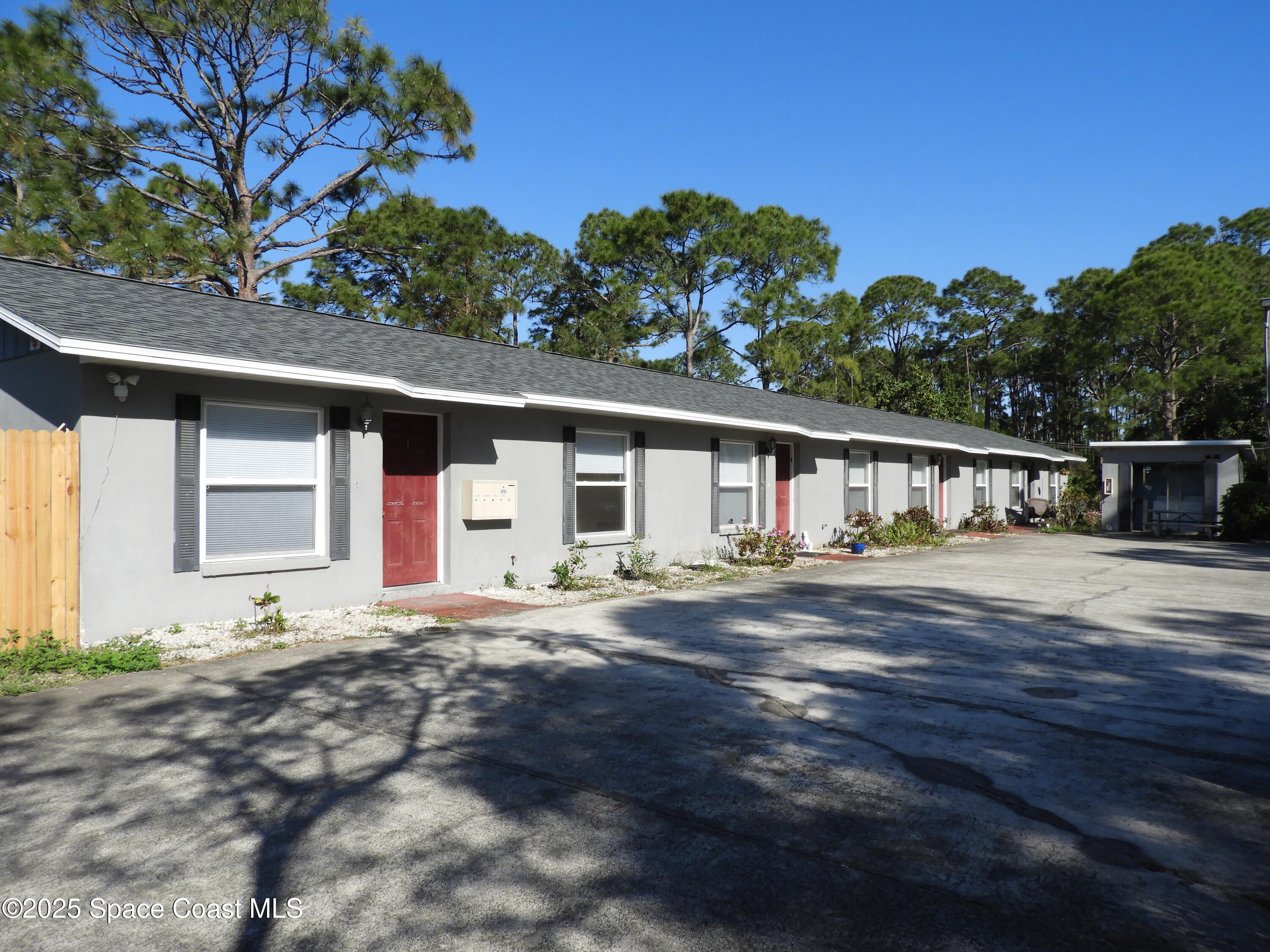 1899 Agora Circle Southeast, Unit 1 Palm Bay, FL 32909 - Photo 1 of 11 a front view of a house with a garden