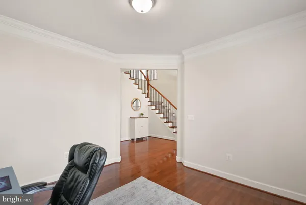 a kitchen with stainless steel appliances granite countertop a stove top oven a refrigerator a sink and a dining table with wooden floor