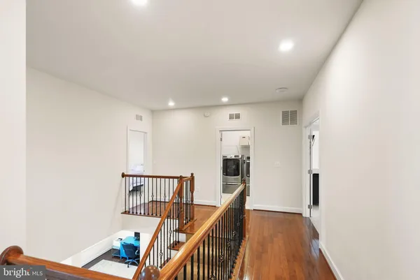 a kitchen with stainless steel appliances granite countertop a kitchen island hardwood floor sink stove and granite counter top