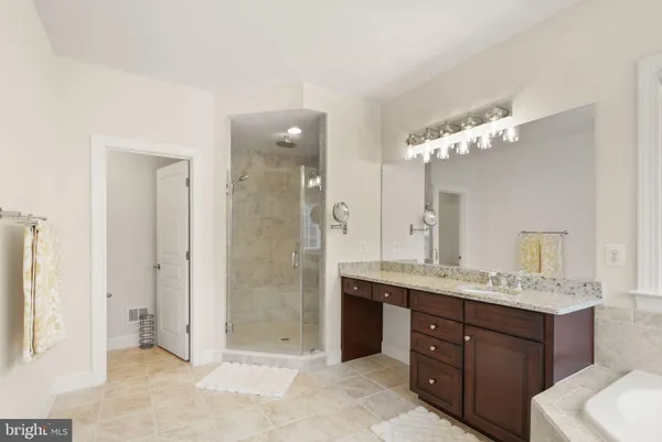 a spacious bathroom with a sink a mirror and shower