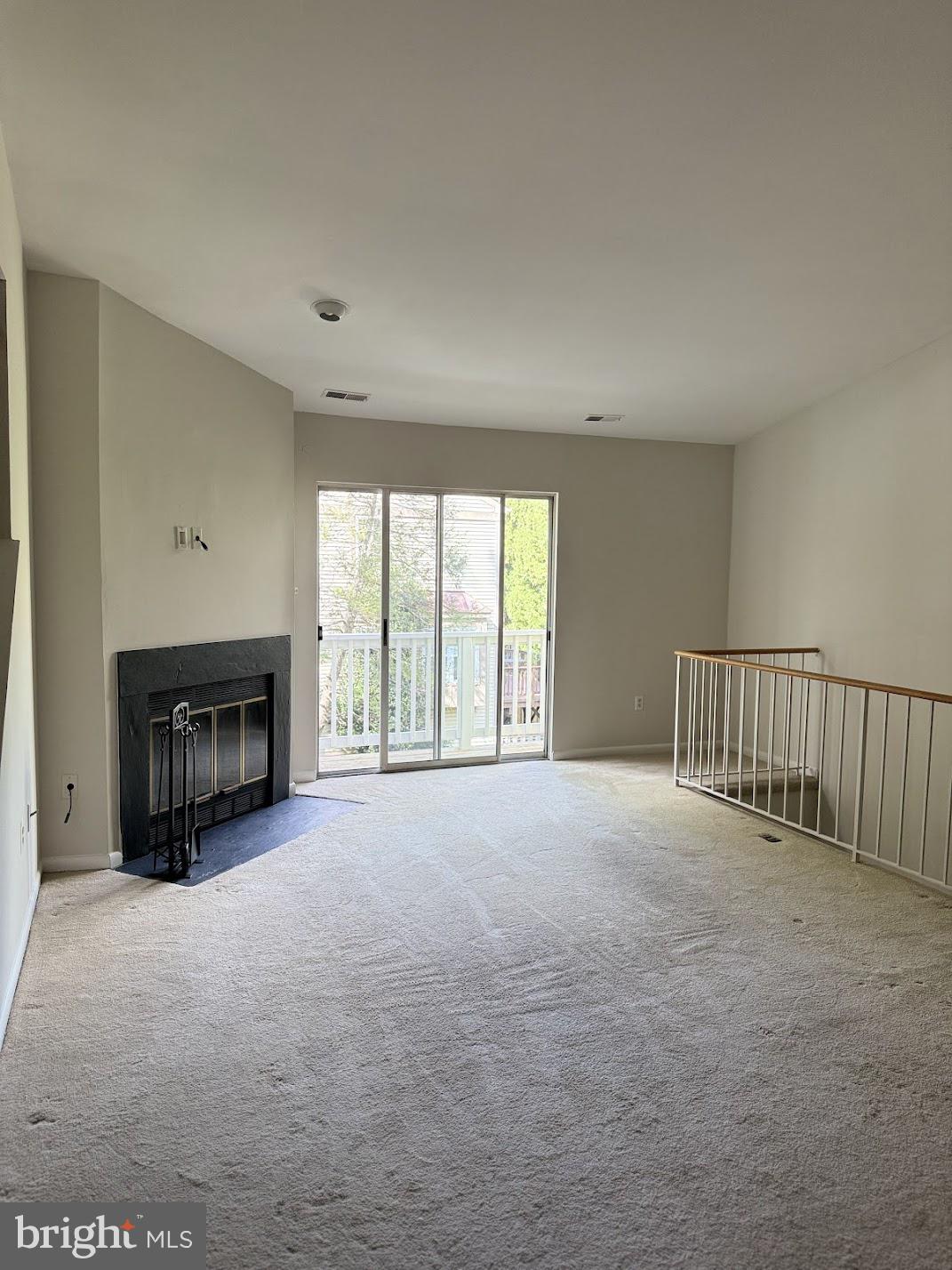 18290 Rolling Meadow Way, Unit 4 Olney, MD 20832 - Photo 3 of 18 a view of an empty room with a fireplace and a window
