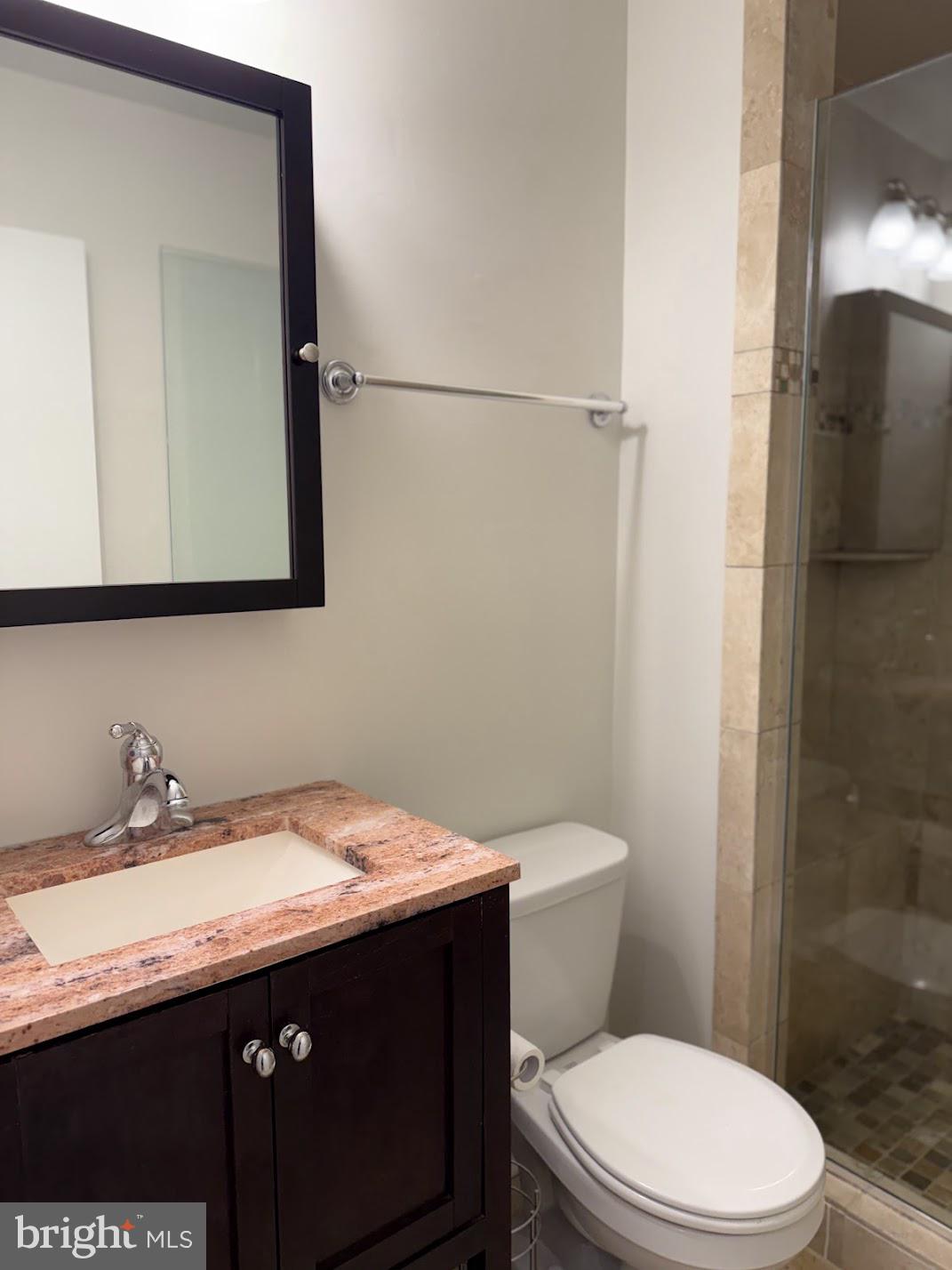 18290 Rolling Meadow Way, Unit 4 Olney, MD 20832 - Photo 4 of 18 a bathroom with a granite countertop toilet sink and mirror