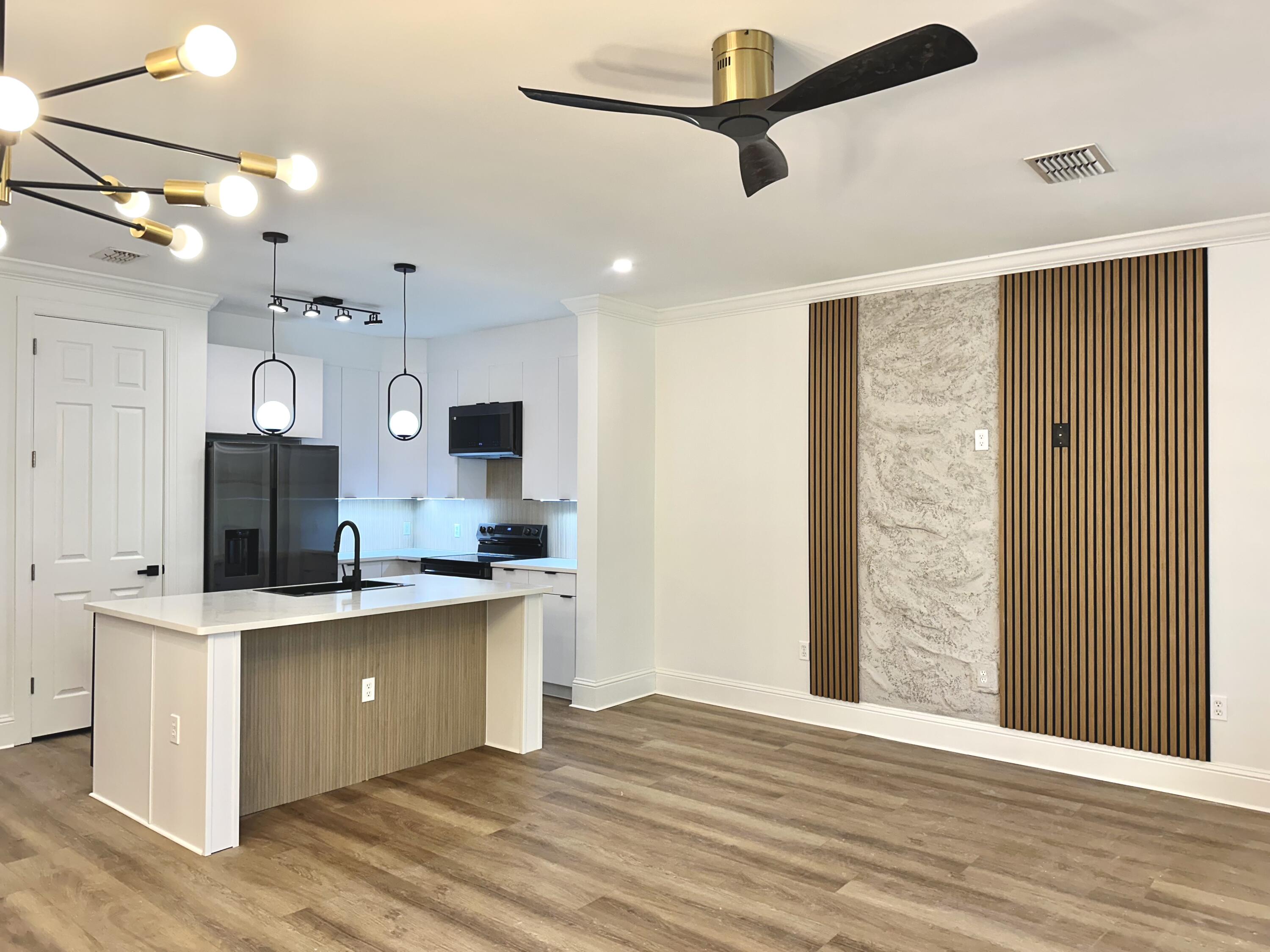 a view of a kitchen with a sink stainless steel appliances and cabinets