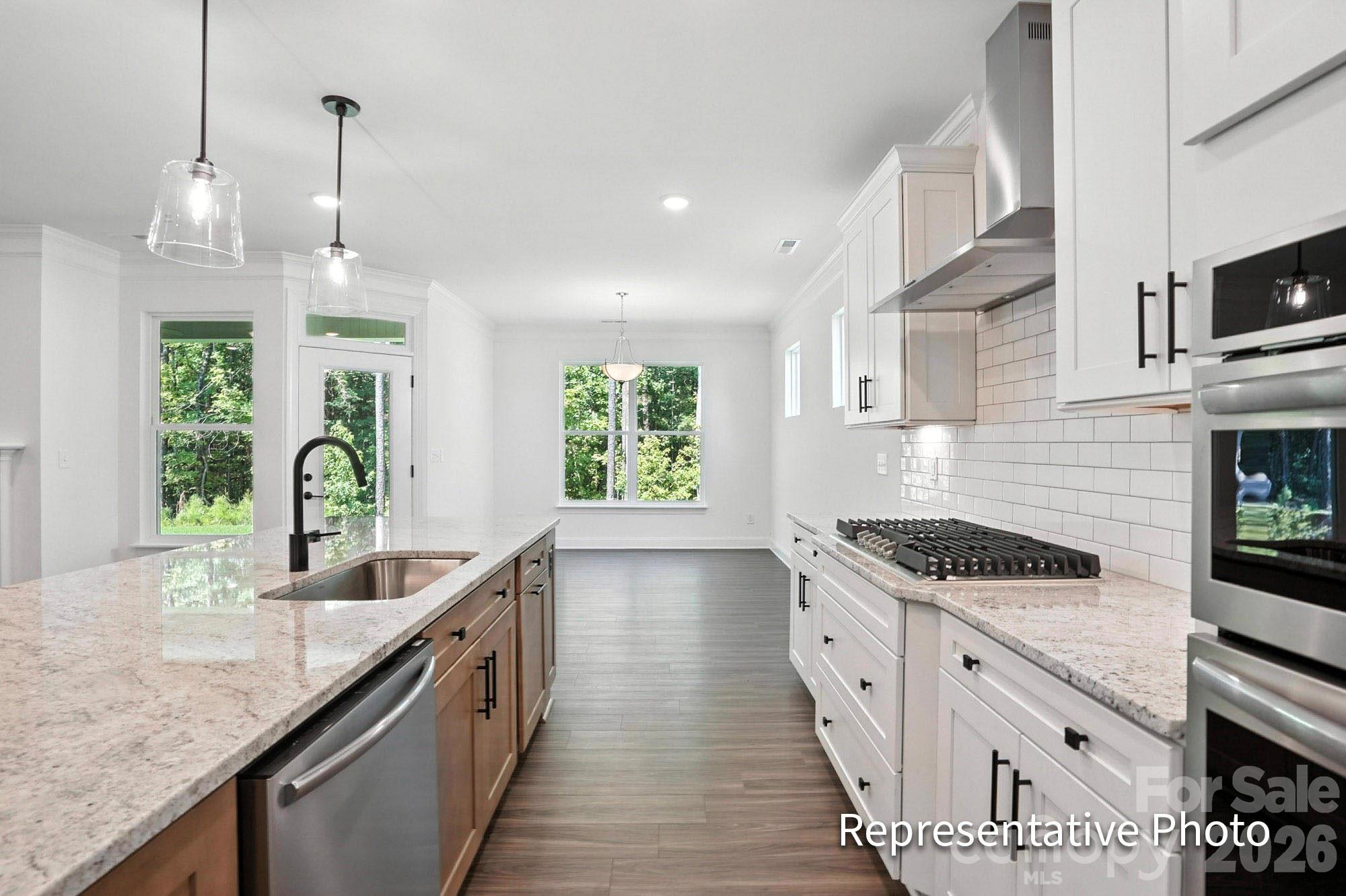2245 Tabor Road Sherrills Ford, NC 28673 - Photo 5 of 34 a kitchen with granite countertop a stove and a sink