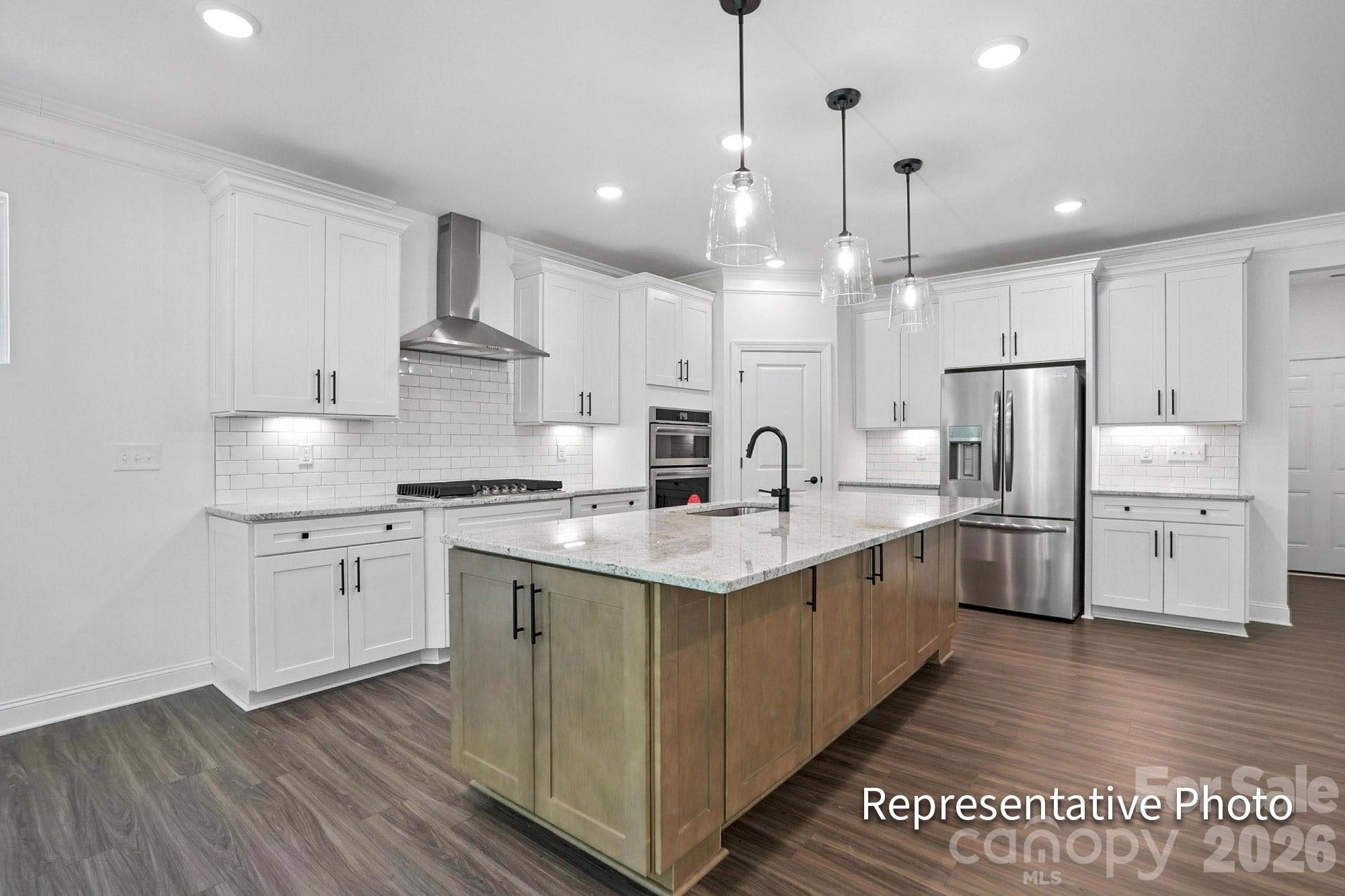 2245 Tabor Road Sherrills Ford, NC 28673 - Photo 6 of 34 a kitchen with stainless steel appliances granite countertop a sink stove a refrigerator and white cabinets with wooden floor