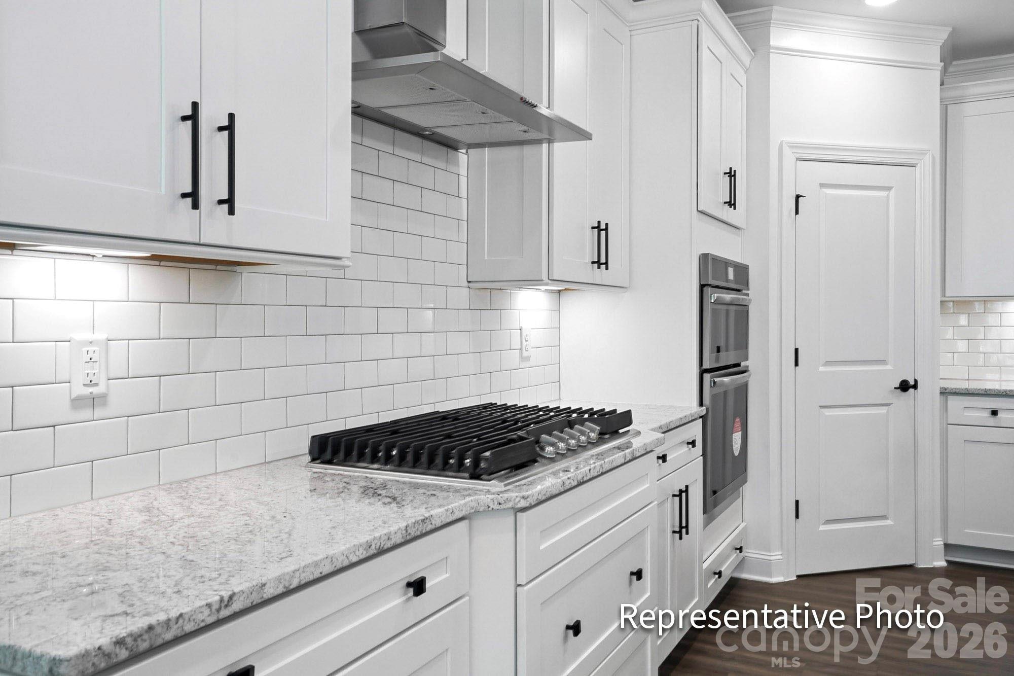 2245 Tabor Road Sherrills Ford, NC 28673 - Photo 7 of 34 a kitchen with white cabinets and a stove