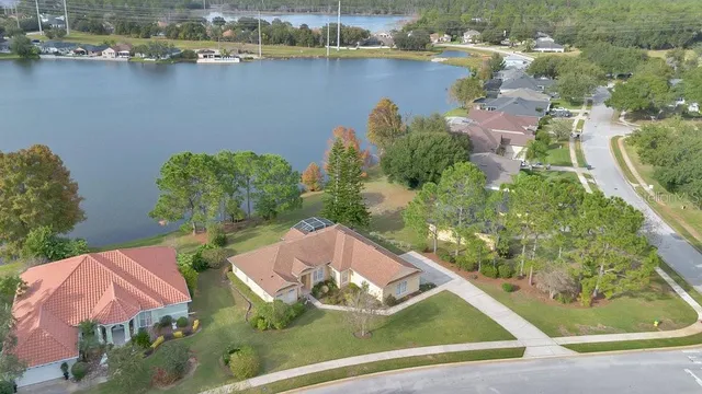 an aerial view of a house with a lake view