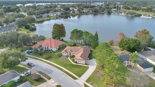 an aerial view of a house with a lake view