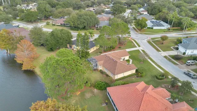 an aerial view of a house with a yard and lake view