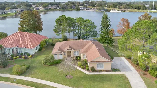 an aerial view of house with yard and lake view
