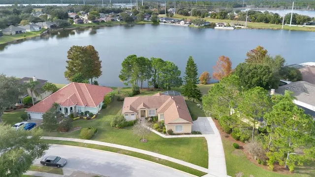 an aerial view of a house with a lake view