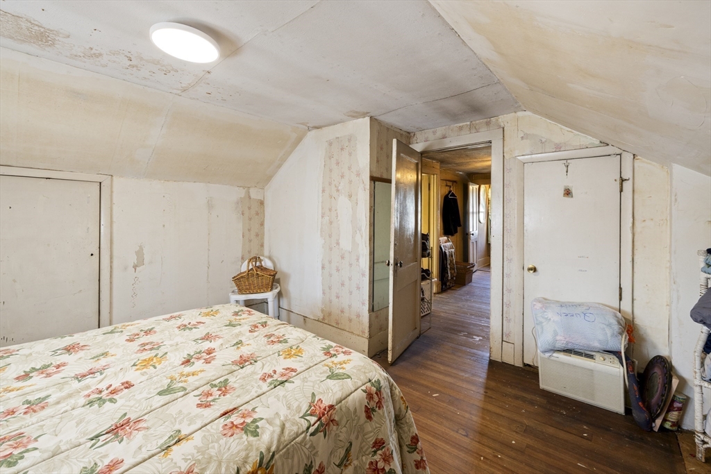 22-25 Macomber Road Monson, MA 01057 - Photo 26 of 34 a bedroom with a bed and wooden floor