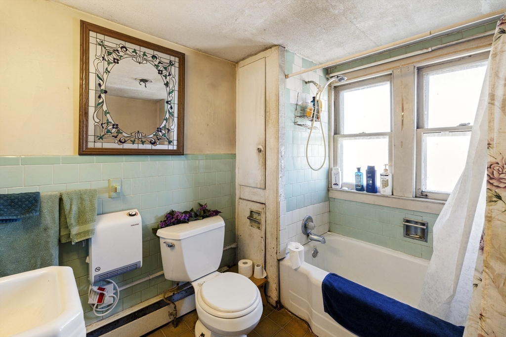 22-25 Macomber Road Monson, MA 01057 - Photo 28 of 34 a white toilet sitting next to a bathroom sink and a tub