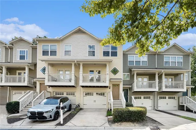 a car parked in front of a white building
