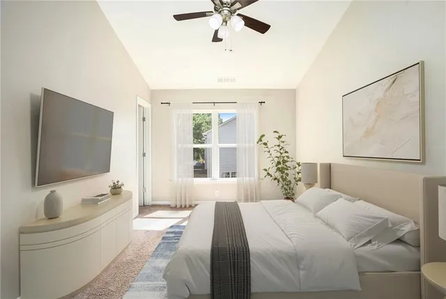 a bedroom with a large bed and a flat screen tv