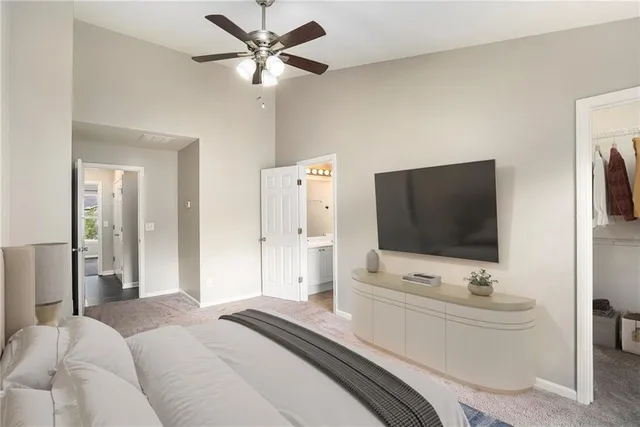 a bedroom with a bed a tv and wooden floor