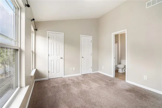 a view of an empty room and a window