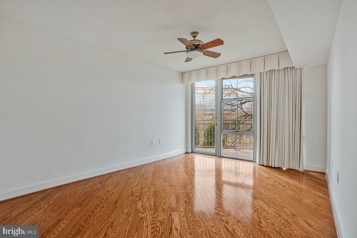 11800 Sunset Hills Road, Unit 514 Reston, VA 20190 - Photo 42 of 57 a view of an empty room with wooden floor and a window