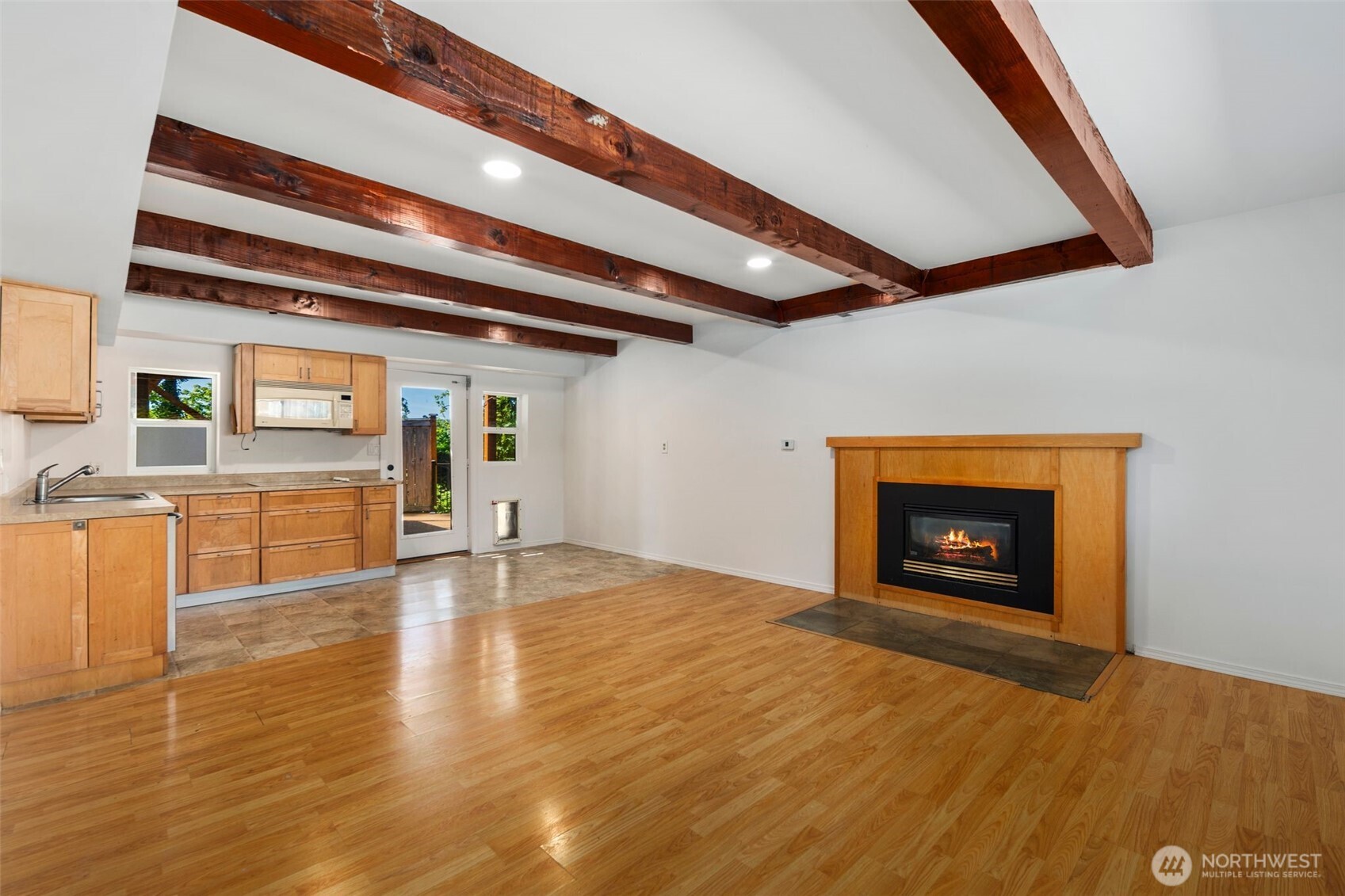 20101 95th Place Northeast Bothell, WA 98011 - Photo 13 of 37 a view of an empty room with wooden floor and a fireplace