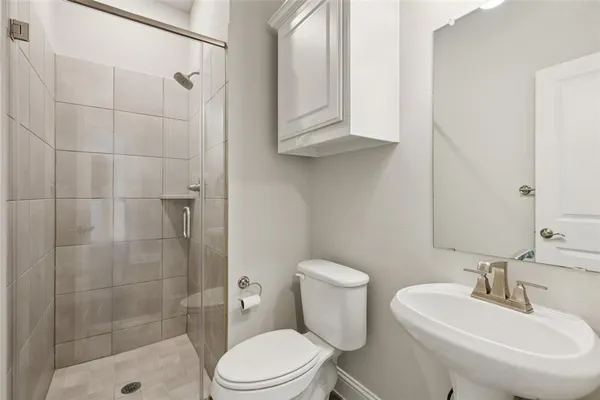 a bathroom with a sink toilet and shower