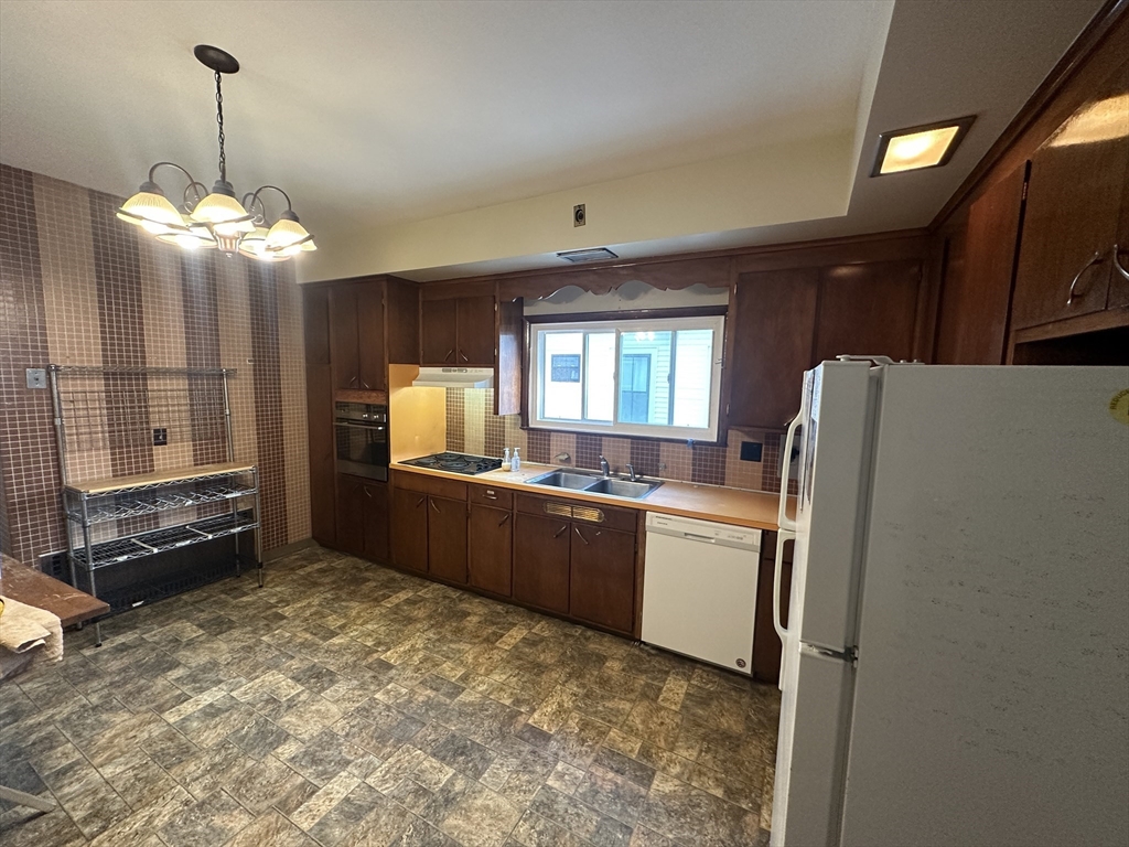 a kitchen with refrigerator and window