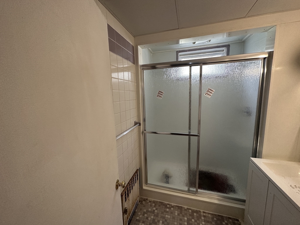 74 Pearson Avenue, Unit 2 Somerville, MA 02144 - Photo 11 of 11 a bathroom with a glass shower door