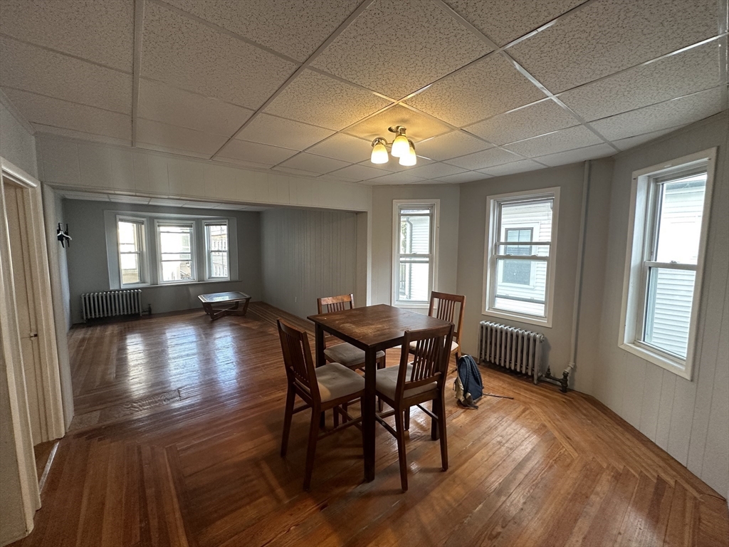 74 Pearson Avenue, Unit 2 Somerville, MA 02144 - Photo 10 of 11 a view of a dining room with furniture and wooden floor