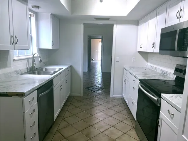 a kitchen with a sink and cabinets