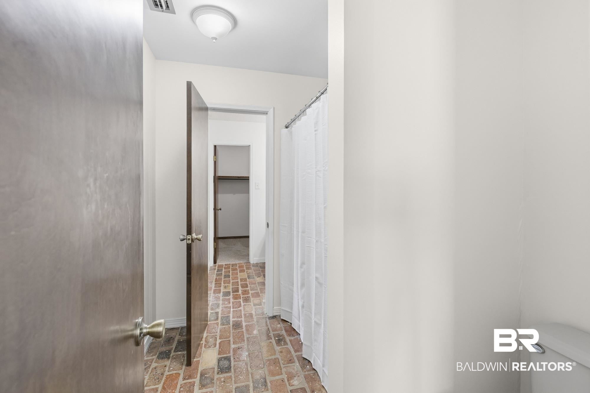 9215 Shiloh Drive Mobile, AL 36695 - Photo 24 of 32 Bathroom featuring brick floors and a shower with curtain