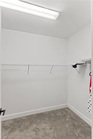 a bathroom with a granite countertop toilet and a shower